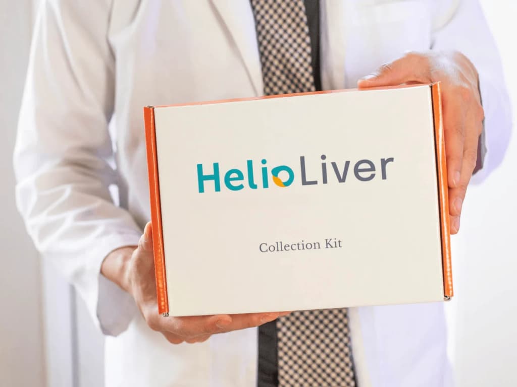 A clinician holding the HelioLiver LDT Collection Kit box