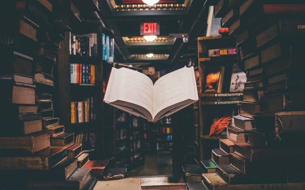 An open book floating in a library of books