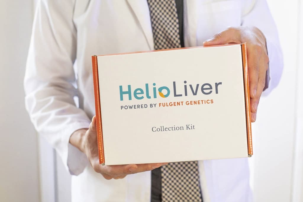 A physician holding the HelioLiver blood test kit
