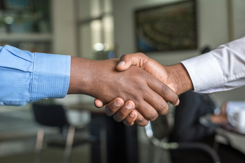 Helio Genomics and Syneos Health commercial partnership handshake