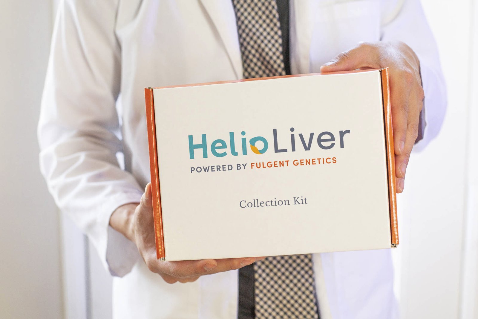 A physician holding the HelioLiver blood test kit