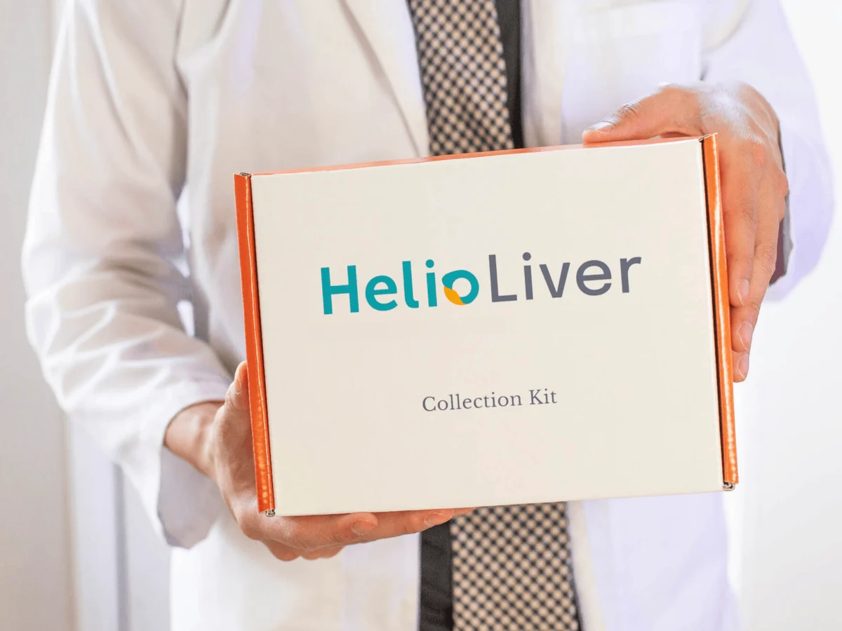 A clinician holding the HelioLiver LDT Collection Kit box