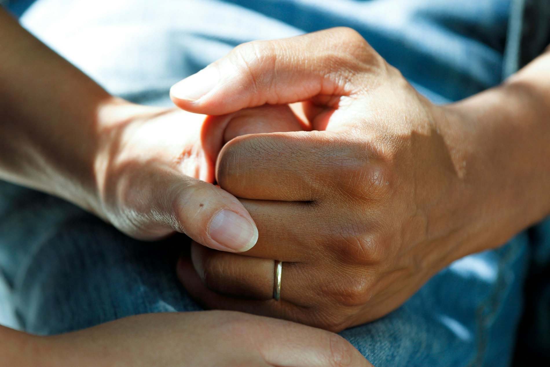 Two people holding hands in support