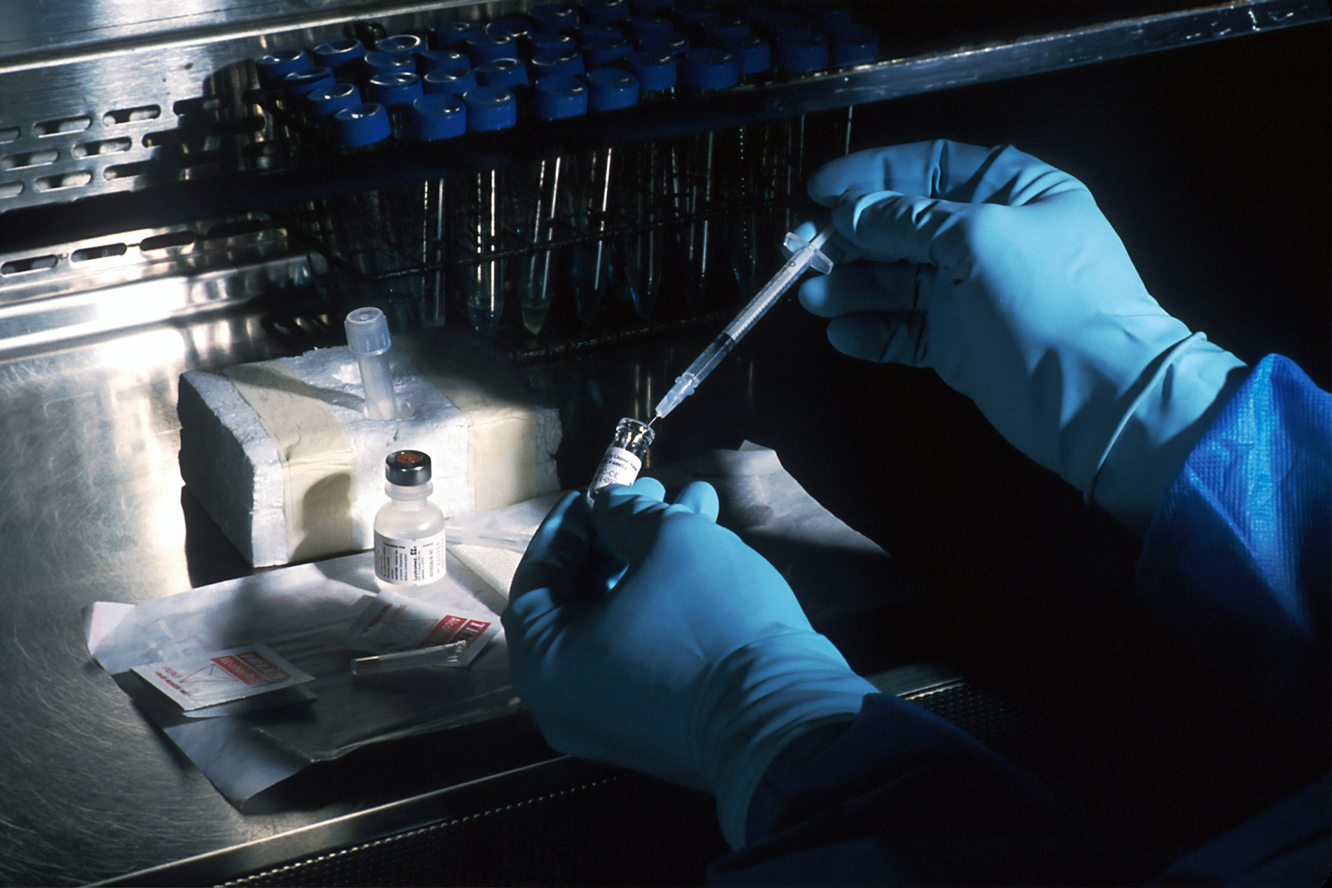 Clinical researcher analyzing blood samples in a genomics laboratory